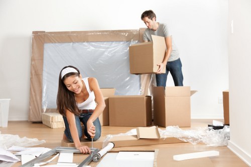 Professional movers handling office equipment during a business relocation