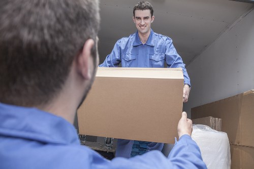 Removal team handling household furniture in Teddington