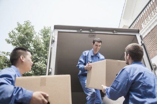 Student removals service handling boxes in Teddington near a residential property