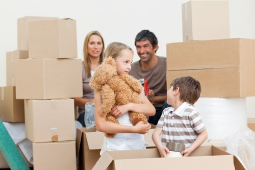 Professional movers handling furniture in a Teddington apartment building